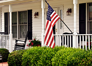 Home with American Flag on Porch with Homeowners Insurance in Collegeville, PA, Limerick, PA, Phoenixville, PA